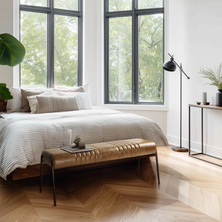Brown leather upholstered bench with steel legs